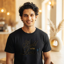 A professional portrait of Sameer Joshi wearing a black cotton T-shirt with a brush-style inspirational quote.