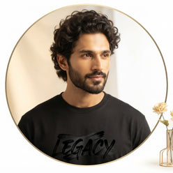 Arjun Khanna wearing a black brush-style inspirational quote T-shirt in a professional editorial portrait.